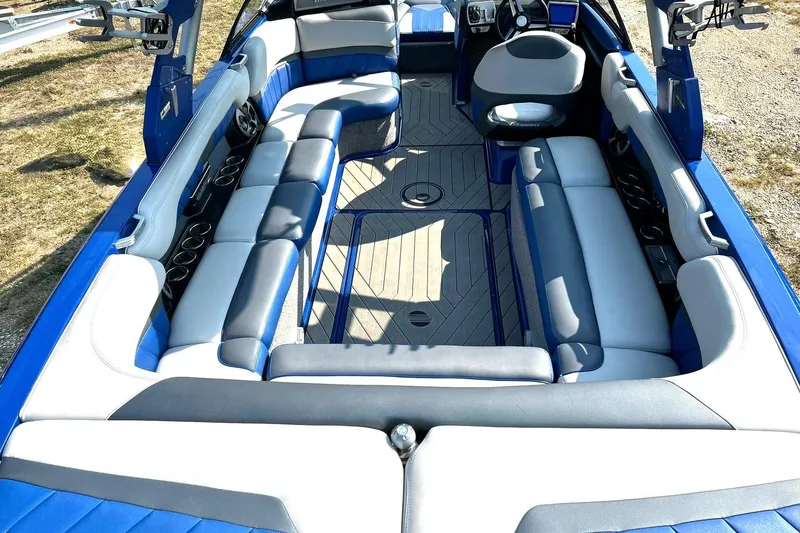 Slide: The Image of 2017 Malibu Wakesetter 25 LSV interior with blue and gray seating, spacious layout. - 30