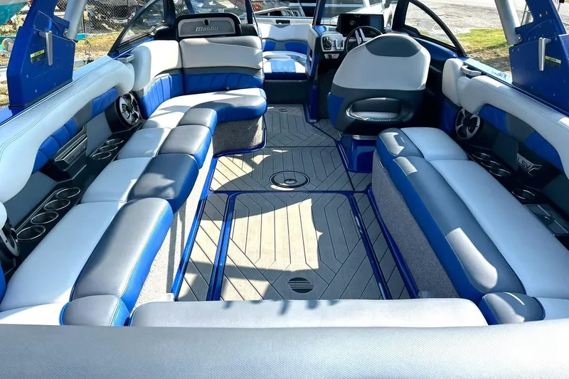 Slide: The Image of 2017 Malibu Wakesetter 25 LSV interior with blue and gray seating, spacious layout. - 31