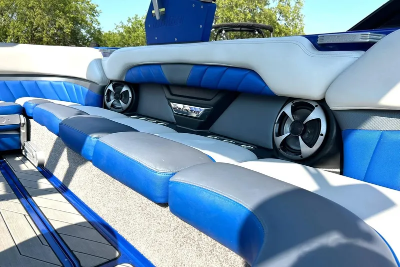 Slide: The Image of 2017 Malibu Wakesetter 25 LSV interior with blue and gray seating, featuring built-in speakers. - 34