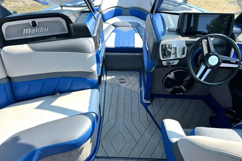 Slide: The Image of 2017 Malibu Wakesetter 25 LSV interior with blue and gray seating, modern dashboard. - 36