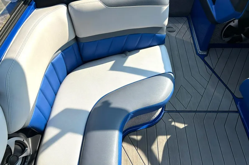 Slide: The Image of 2017 Malibu Wakesetter 25 LSV interior with blue and gray seating, stylish boat design. - 37