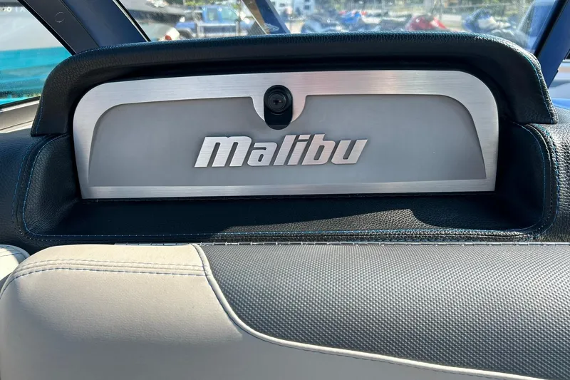 Slide: The Image of 2017 Malibu Wakesetter 25 LSV dashboard with logo, featuring sleek design and leather accents. - 38