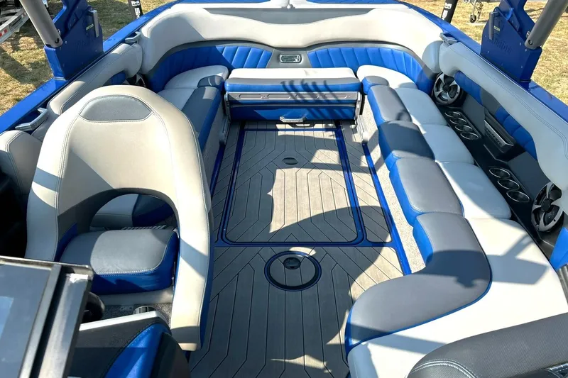 Slide: The Image of 2017 Malibu Wakesetter 25 LSV interior with blue and gray seating, cup holders, and spacious layout. - 4