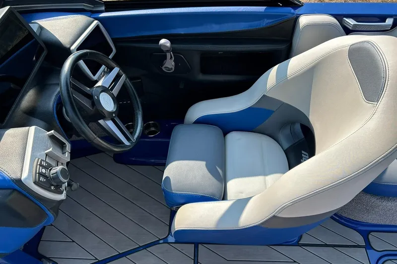 Slide: The Image of 2017 Malibu Wakesetter 25 LSV interior with steering wheel and captain's seat. - 40