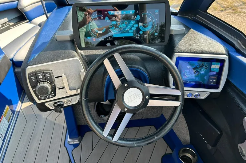 Slide: The Image of 2017 Malibu Wakesetter 25 LSV dashboard with digital displays and steering wheel. - 42
