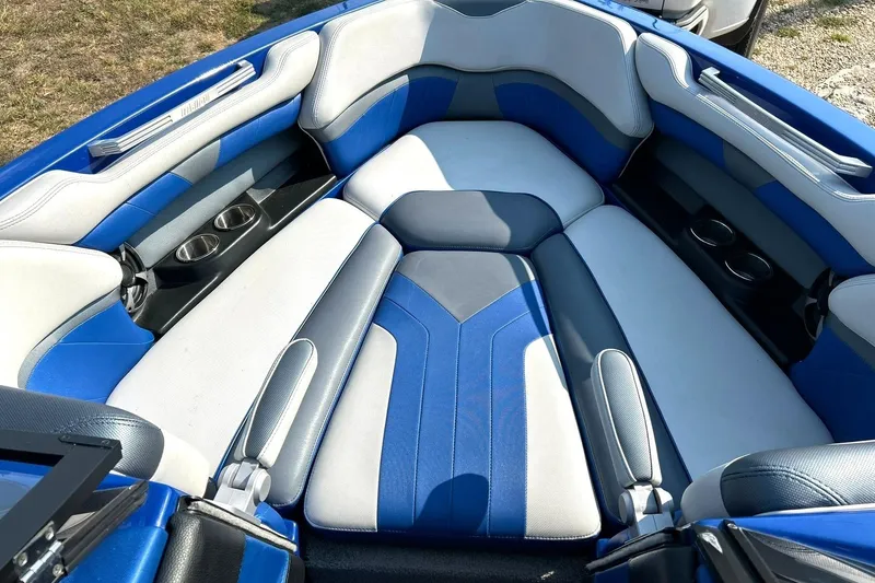 Slide: The Image of 2017 Malibu Wakesetter 25 LSV interior with blue and white seating, cup holders. - 48