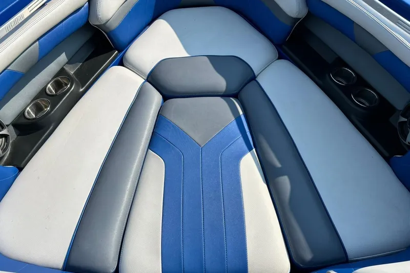 Slide: The Image of 2017 Malibu Wakesetter 25 LSV interior with blue and gray seating and cup holders. - 49