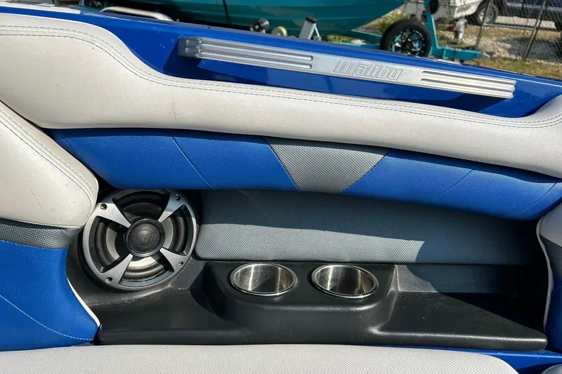 Slide: The Image of 2017 Malibu Wakesetter 25 LSV interior with blue upholstery, speaker, and cup holders. - 57