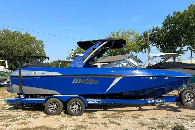 Slide: The Image of 2017 Malibu Wakesetter 25 LSV boat in vibrant blue on a trailer. - 7