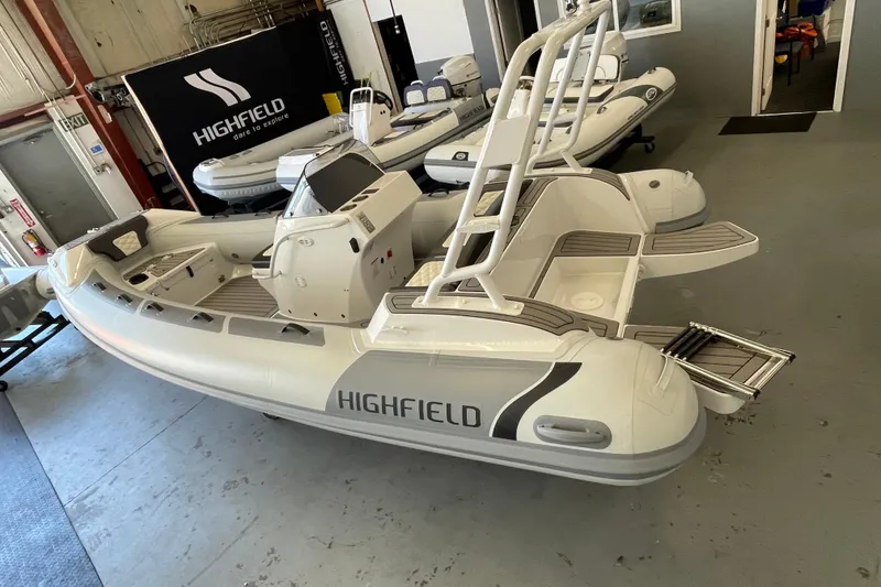 Slide: The Image of 2025 Highfield Sport 520 inflatable boat in showroom, featuring sleek design and modern amenities. - 1