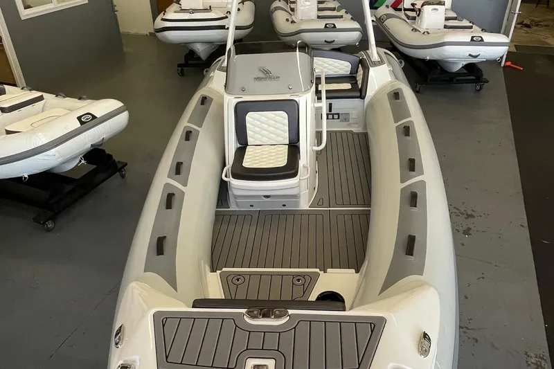 Slide: The Image of 2025 Highfield Sport 520 boat with sleek design and modern seating in showroom. - 3