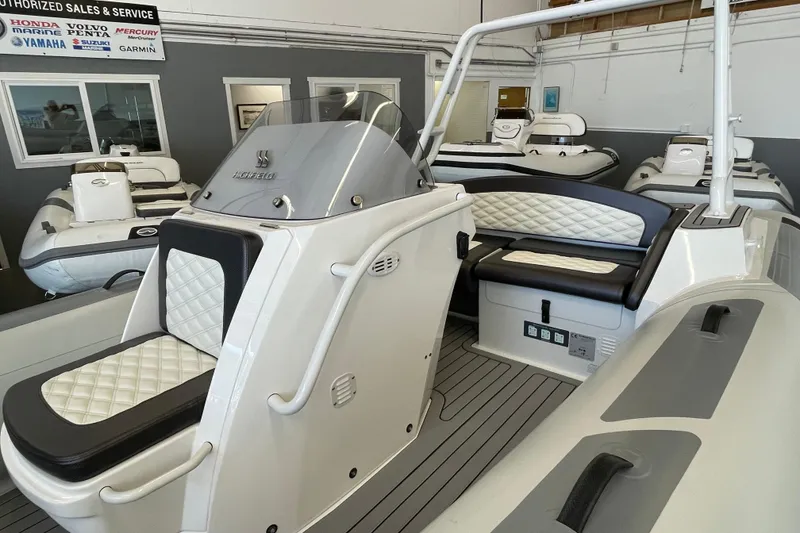 Slide: The Image of 2025 Highfield Sport 520 boat interior with sleek seating and modern design in showroom. - 6