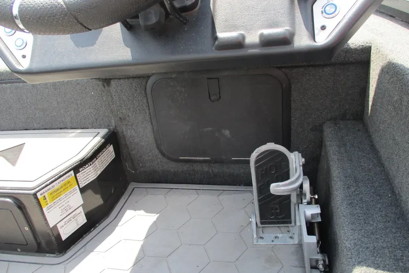 Slide: The Image of Interior of a 2021 Avid 20XB boat showing steering wheel and foot pedal. - 12