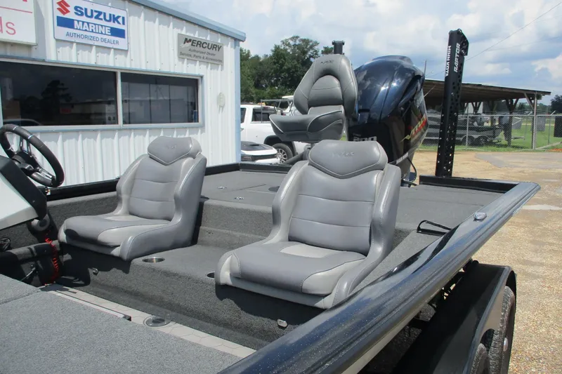 Slide: The Image of 2021 Avid 20XB boat with gray seats, Suzuki Marine and Mercury signs in background. - 6