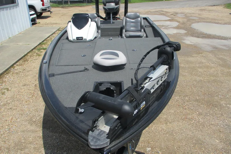 Slide: The Image of 2021 Avid 20XB fishing boat with trolling motor, parked on gravel. - 7