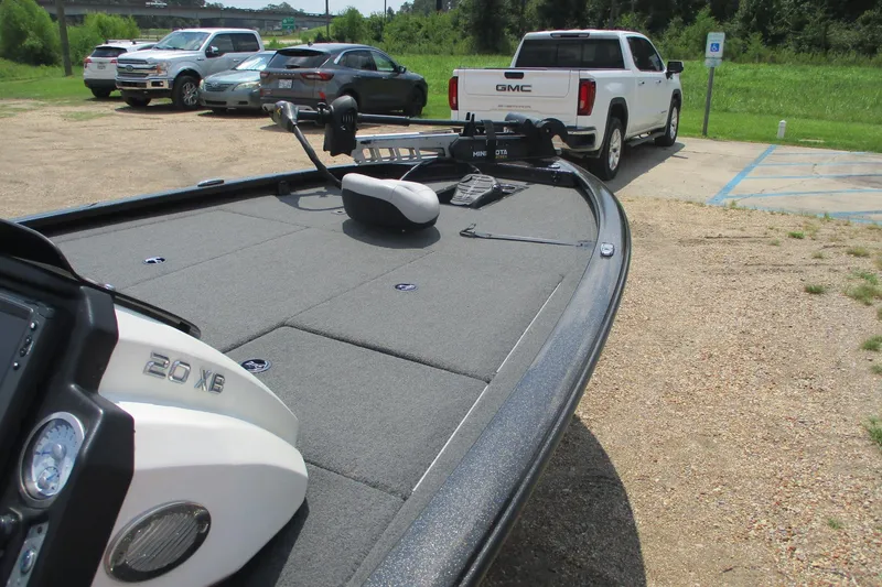 Slide: The Image of 2021 Avid 20XB boat on trailer, parked near GMC truck in sunny lot. - 9