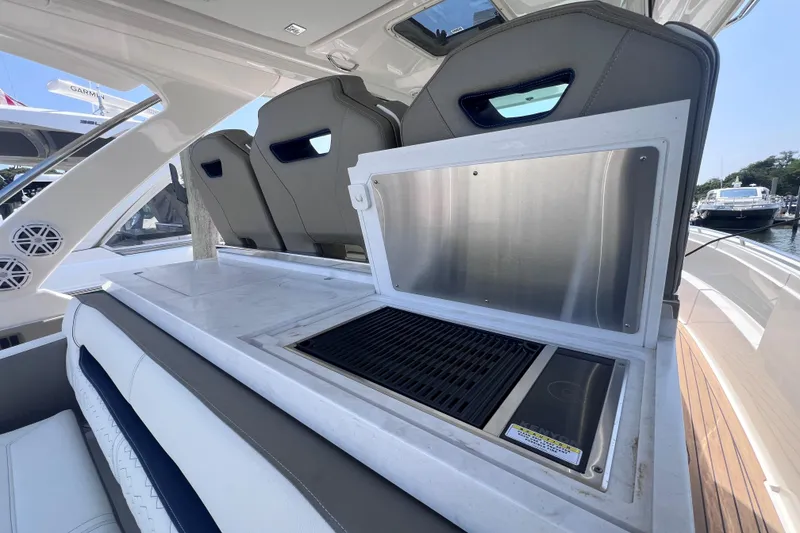 Slide: The Image of Luxury 2022 Tiara Yachts 34 LS with sleek onboard grill and seating area. - 10