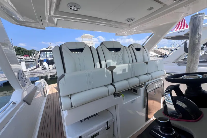 Slide: The Image of 2022 Tiara Yachts 34 LS interior with luxurious seating and modern helm controls. - 11