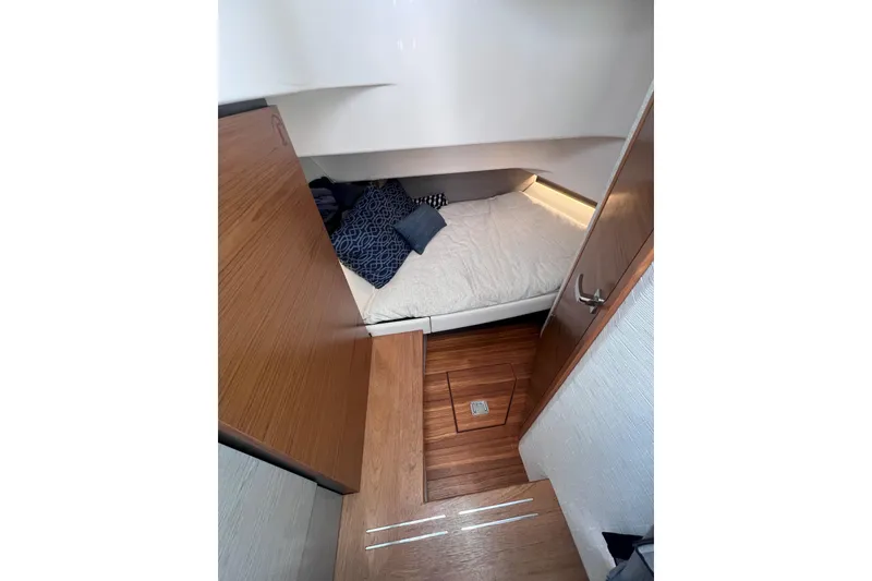 Slide: The Image of 2022 Tiara Yachts 34 LS cabin interior with cozy bed and wooden flooring. - 14