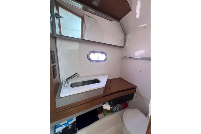 Slide: The Image of 2022 Tiara Yachts 34 LS bathroom with sink, mirror, and storage. - 16