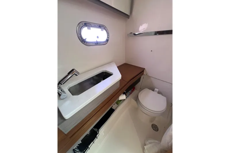 Slide: The Image of 2022 Tiara Yachts 34 LS bathroom with modern sink and toilet. - 17