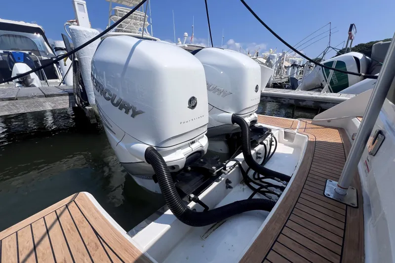 Slide: The Image of 2022 Tiara Yachts 34 LS with dual Mercury outboard engines at marina. - 2