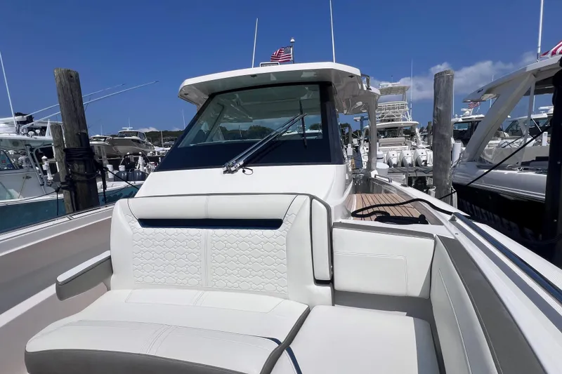 Slide: The Image of 2022 Tiara Yachts 34 LS luxury boat docked, featuring sleek design and comfortable seating. - 20