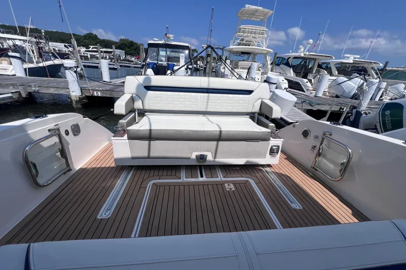 Slide: The Image of 2022 Tiara Yachts 34 LS boat interior with seating at a marina. - 3