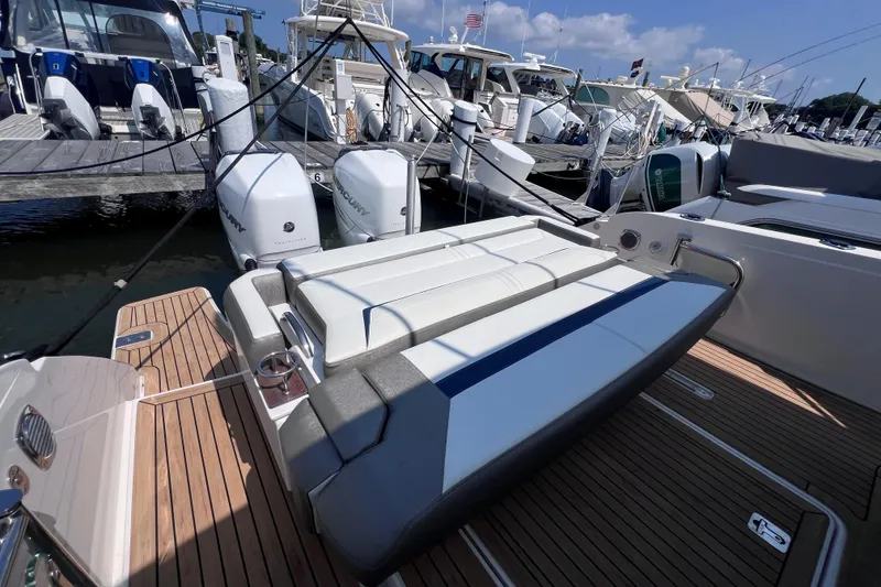 Slide: The Image of 2022 Tiara Yachts 34 LS at marina, featuring sleek design and powerful Mercury engines. - 4