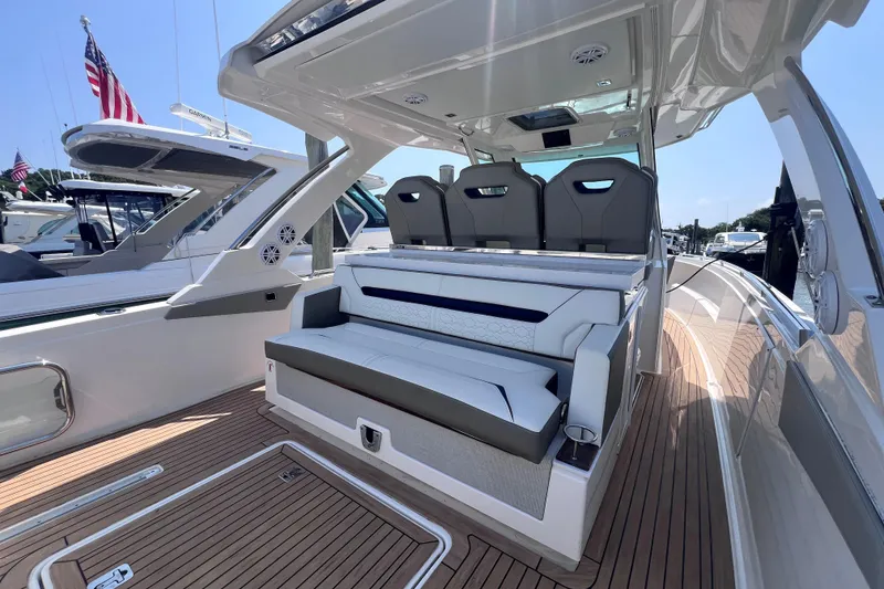 Slide: The Image of 2022 Tiara Yachts 34 LS luxury boat interior with seating and teak flooring. - 7