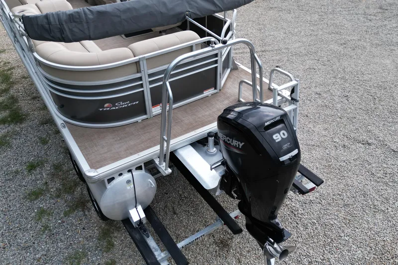 Slide: The Image of 2020 Sun Tracker Party Barge 20 DLX with Mercury 90 outboard motor on gravel. - 8