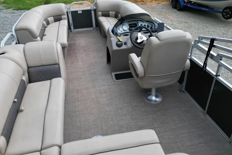 Slide: The Image of 2020 Sun Tracker Party Barge 20 DLX interior with spacious seating and helm. - 9