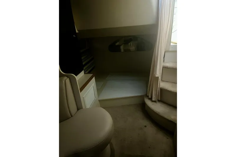 Slide: The Image of 1997 Cruisers Yachts 3075 Rogue interior with seating and steps, featuring neutral tones. - 11