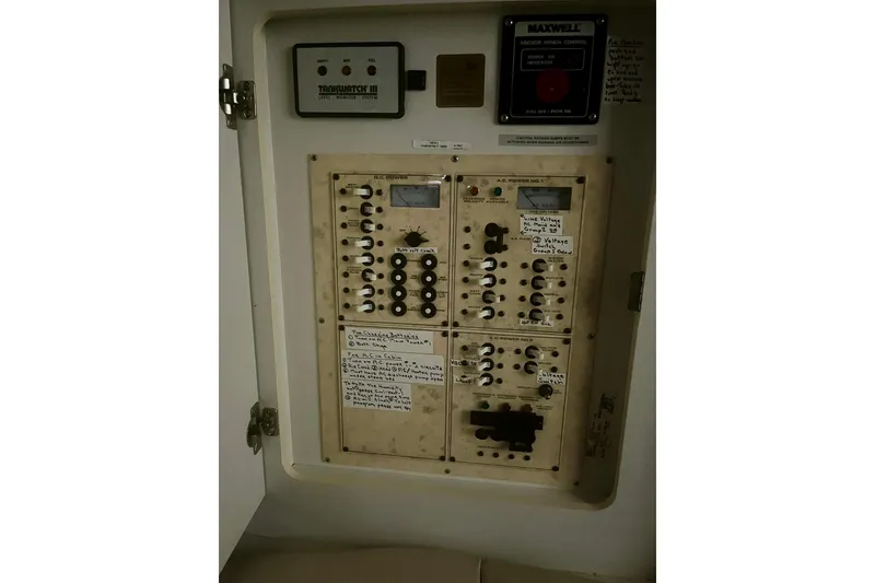 Slide: The Image of Electrical control panel inside 1997 Cruisers Yachts 3075 Rogue, featuring various switches and indicators. - 12