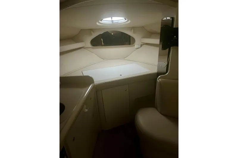Slide: The Image of Interior cabin of 1997 Cruisers Yachts 3075 Rogue, featuring compact seating and storage. - 15