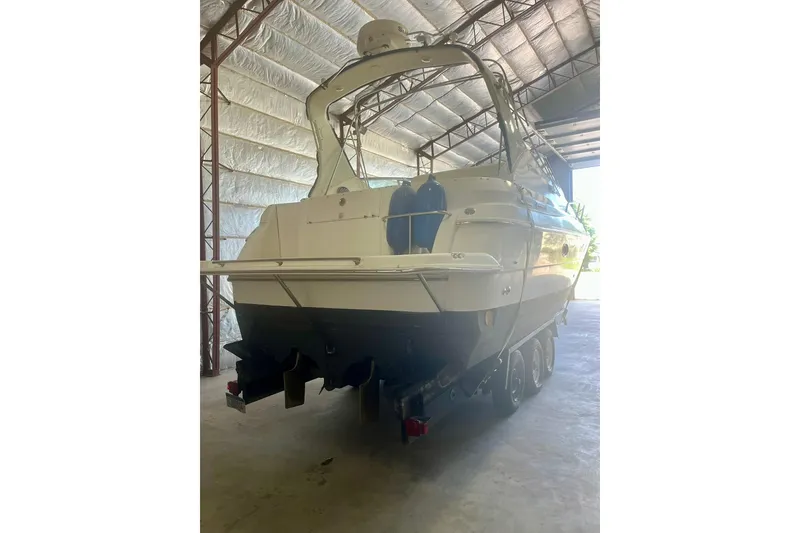 Slide: The Image of 1997 Cruisers Yachts 3075 Rogue in storage, rear view, showcasing sleek design. - 2