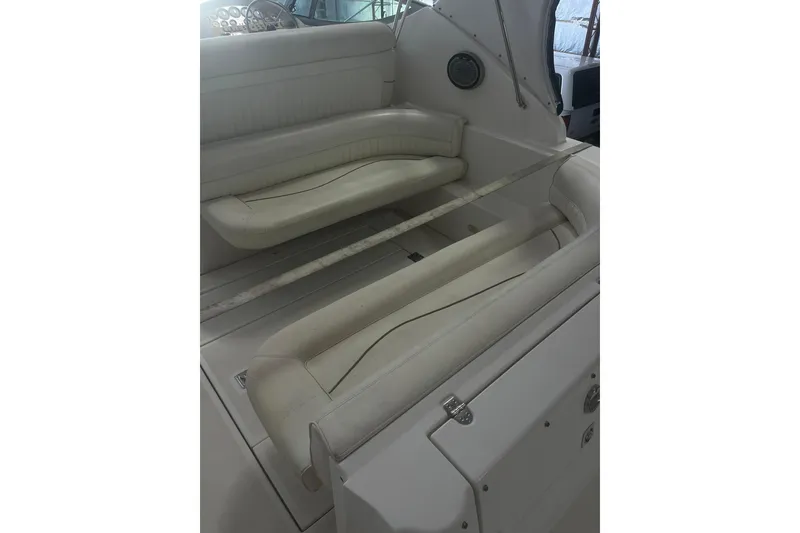 Slide: The Image of 1997 Cruisers Yachts 3075 Rogue interior seating with white upholstery and dashboard view. - 5