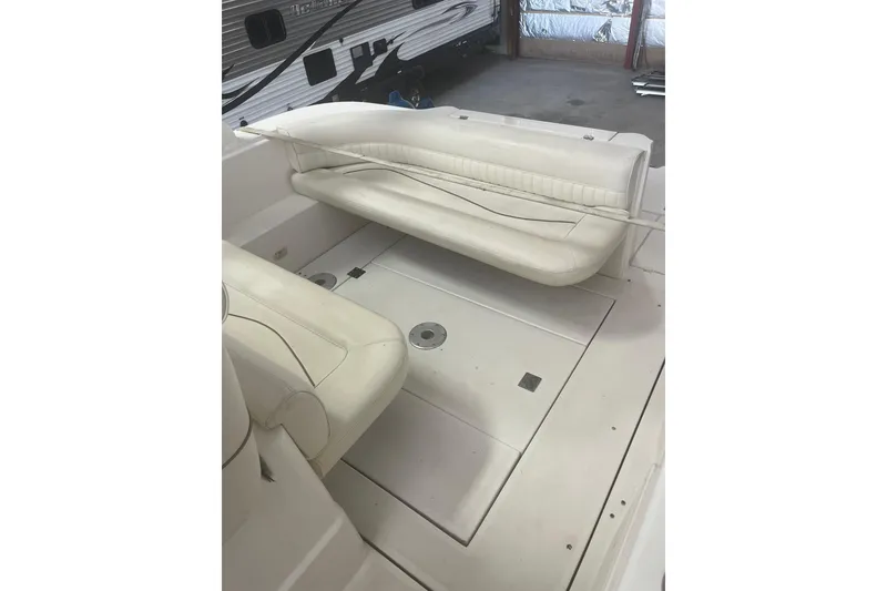 Slide: The Image of 1997 Cruisers Yachts 3075 Rogue interior with white seating and spacious deck area. - 6