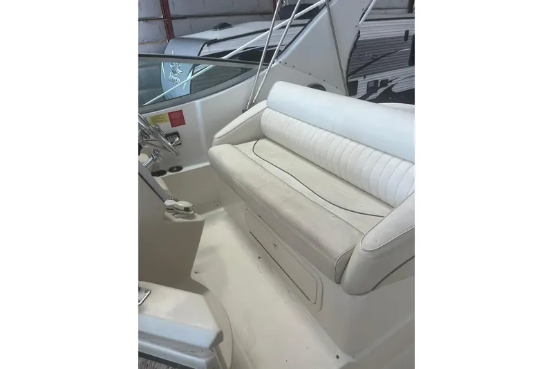 Slide: The Image of 1997 Cruisers Yachts 3075 Rogue cockpit with white seating and steering controls. - 7