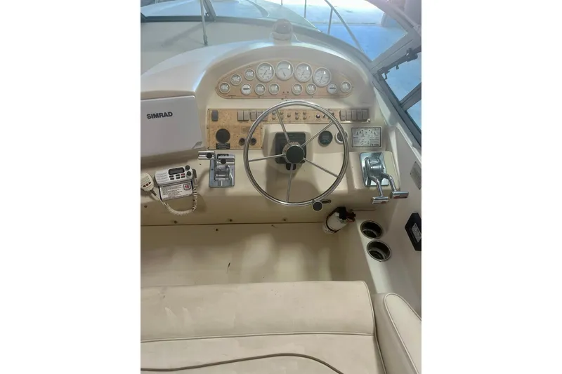 Slide: The Image of 1997 Cruisers Yachts 3075 Rogue helm with steering wheel and navigation instruments. - 8
