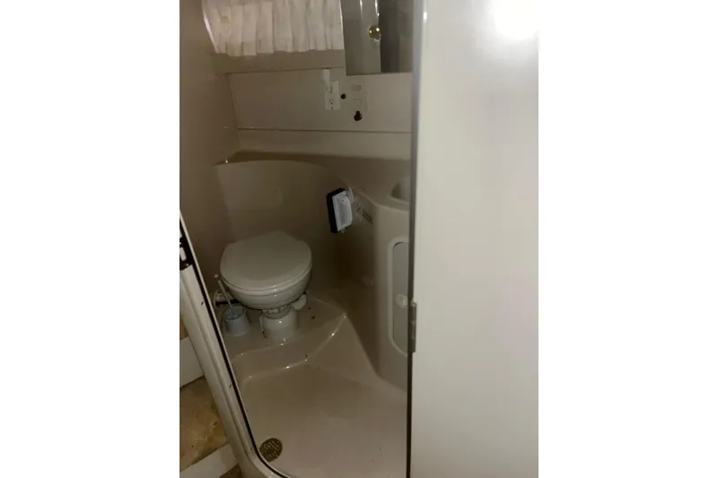 Slide: The Image of 1997 Cruisers Yachts 3075 Rogue bathroom interior with toilet and compact design. - 9
