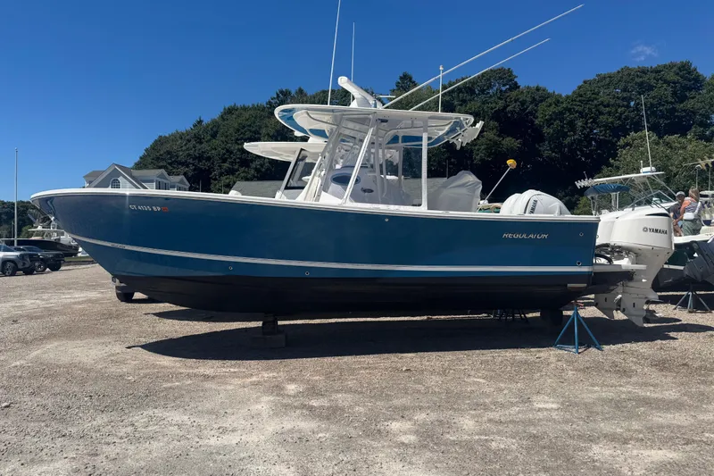 Slide: The Image of 2017 Regulator 28 boat with Yamaha engines on a sunny day. - 1