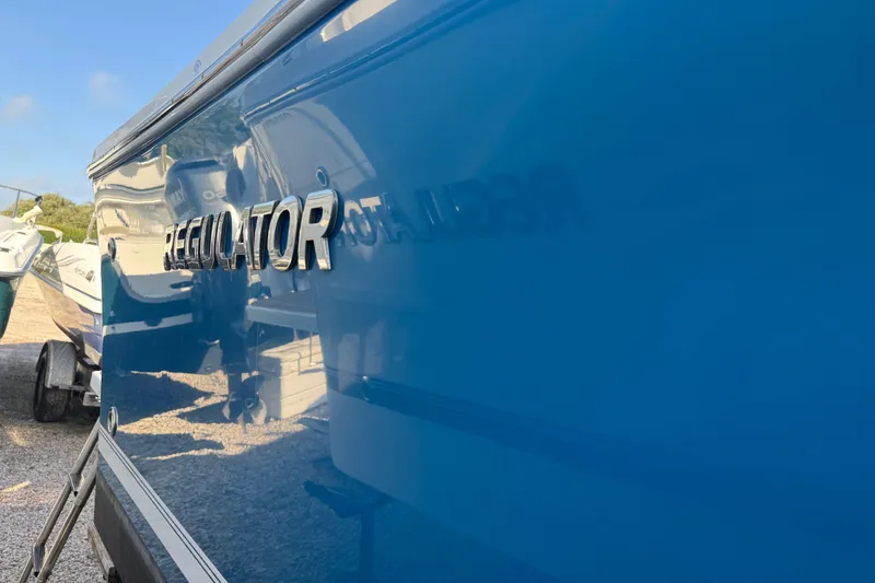 Slide: The Image of 2017 Regulator 28 boat with shiny blue exterior and logo. - 12