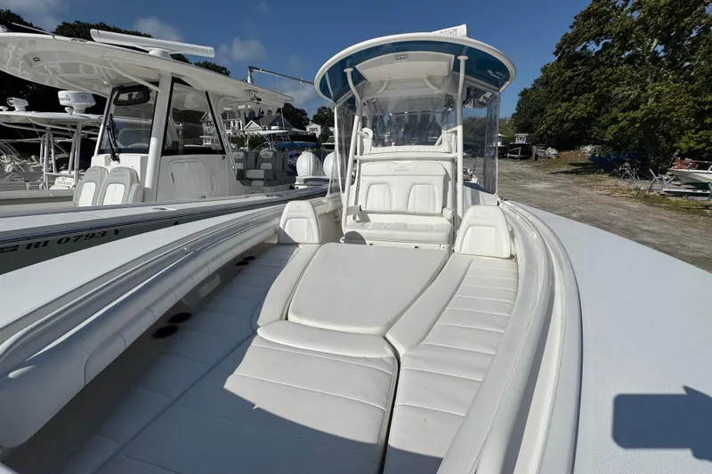 Slide: The Image of 2017 Regulator 28 boat with white seating and console, docked outdoors. - 14