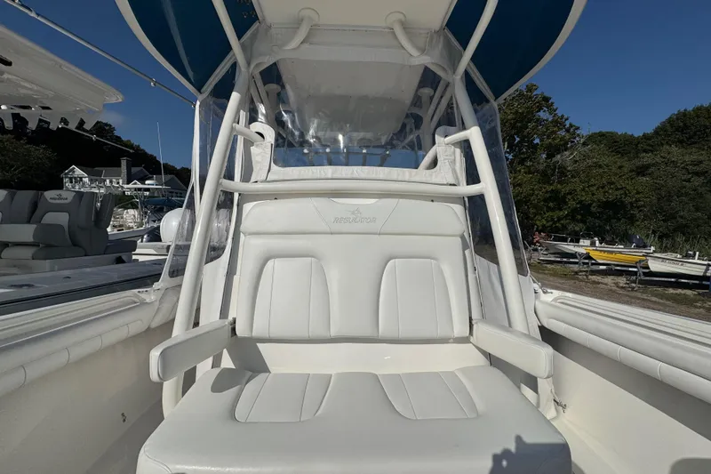 Slide: The Image of 2017 Regulator 28 boat interior with white seating and protective canopy. - 16