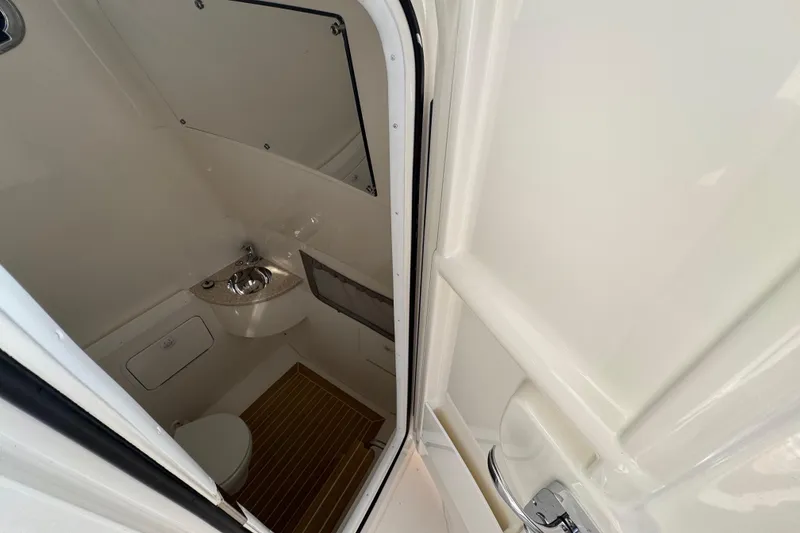 Slide: The Image of Interior of 2017 Regulator 28 boat bathroom with sink and toilet. - 20