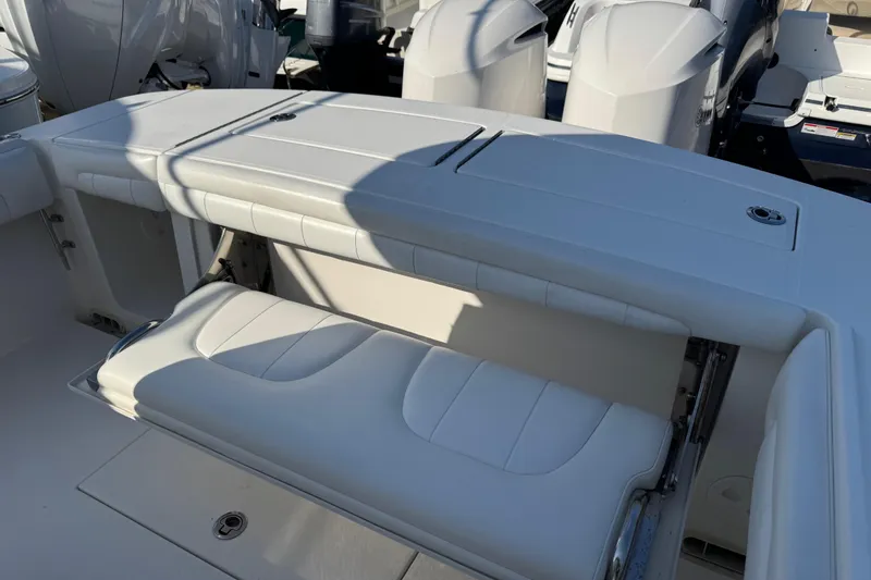 Slide: The Image of 2017 Regulator 28 boat with white seating and multiple outboard engines. - 23