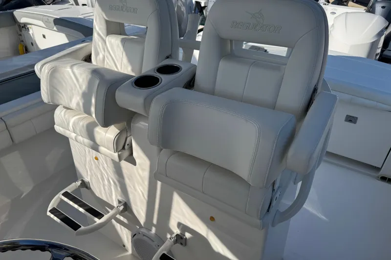 Slide: The Image of 2017 Regulator 28 boat seats with cup holders and footrests in a sleek design. - 25