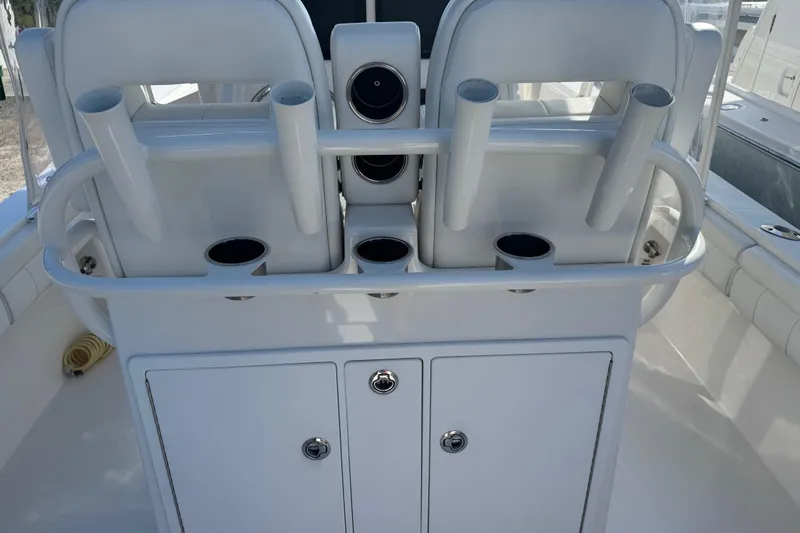 Slide: The Image of 2017 Regulator 28 boat interior with rod holders and storage compartments. - 26