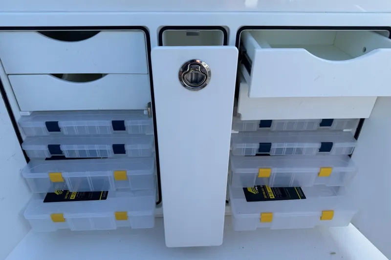 Slide: The Image of Storage compartments with tackle boxes on a 2017 Regulator 28 boat. - 27